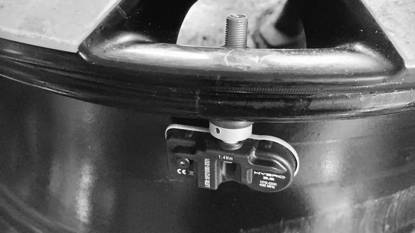 A technician programming a tyre pressure monitoring sensor