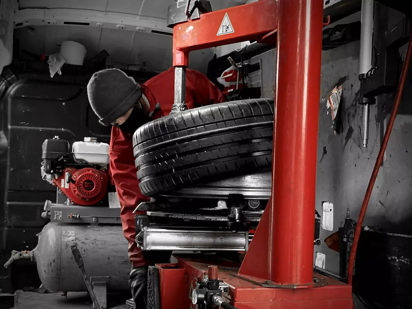 Technician using a tyre fitting machine inside a Freeway mobile tyre van